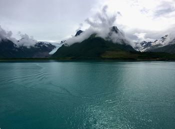 Scenic view of lake and mountains against sky