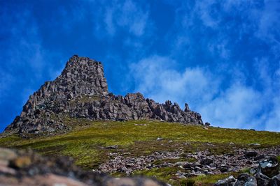 Rock formations on landscape against blue sky