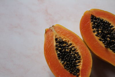 High angle view of orange fruit against white background