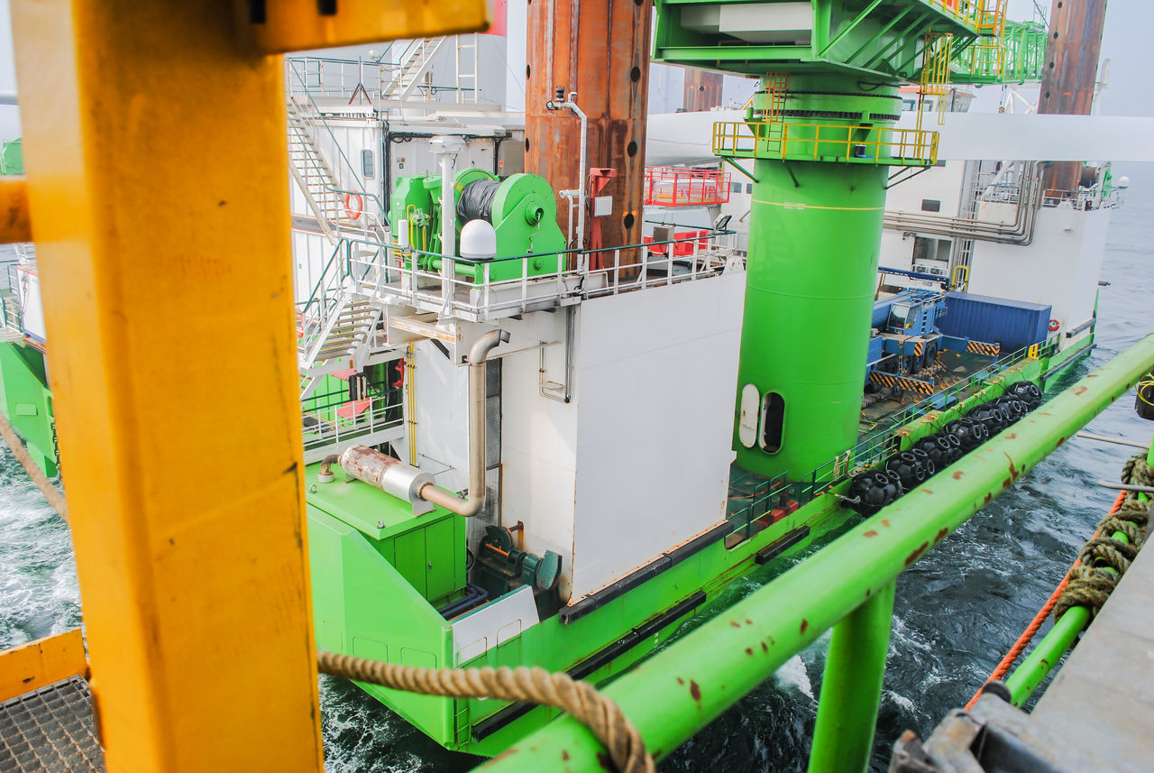 HIGH ANGLE VIEW OF MACHINERY ON FACTORY BY INDUSTRY