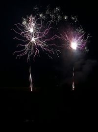 Low angle view of firework display at night