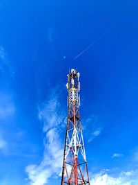 Low angle view of communications tower against blue sky