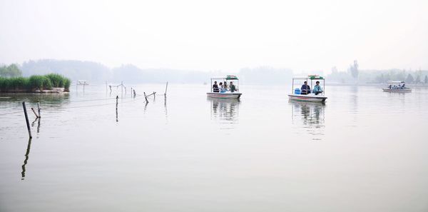 Boats in calm lake