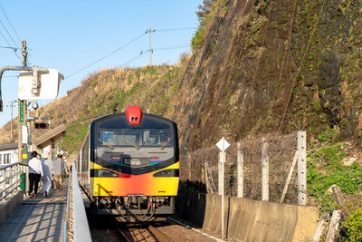 Train on railroad track against sky