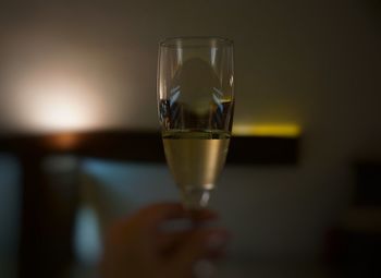 Close-up of hand holding wine in glass