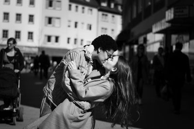 Lesbians kissing while standing on city street