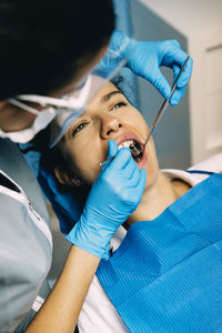 Dentist examining woman in clinic