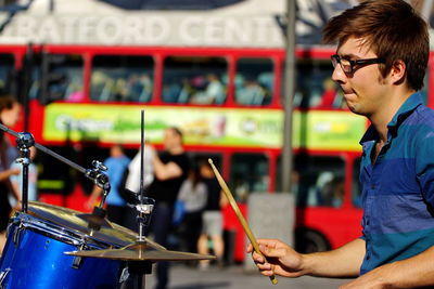 Man playing drums in city