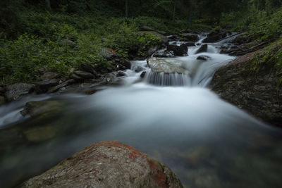 Stream flowing through rocks in forest