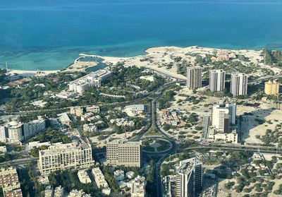 High angle view of townscape by sea