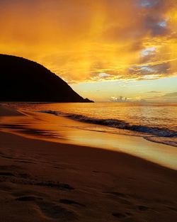 Scenic view of sea against orange sky