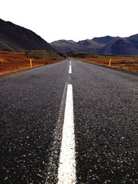 Empty road along trees