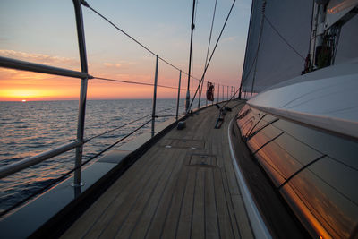 Boat deck against sky during sunset