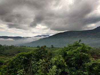 Scenic view of mountains against cloudy sky