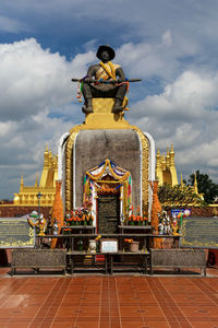 Statue of the king chao anouvong in front of the pha that luang stupa in vientiane, laos.