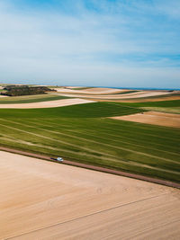 Aerial view of agricultural field against sky