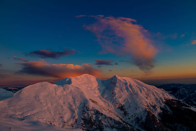 Scenic view of snowcapped mountains against sky during sunset