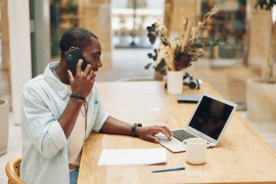 Man using laptop on table