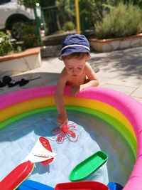 Boy playing with swimming pool