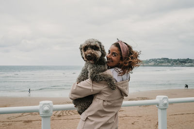 Happy woman with dog at beach