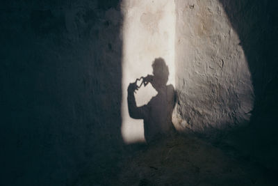 High angle view of man with heart shape shadow on wall