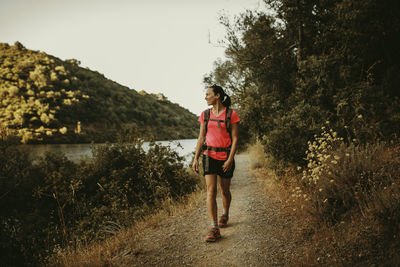 Full length of woman standing on land against sky