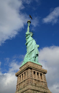 Low angle view of statue against cloudy sky