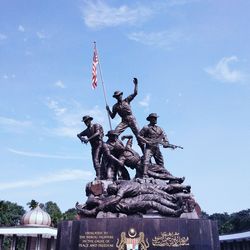 Low angle view of statue against cloudy sky