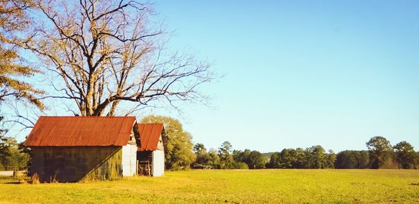 Barn on field against clear sky