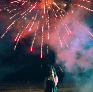 Low angle view of firework display at night