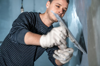 Midsection of man working in workshop