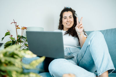 Young woman using laptop at home