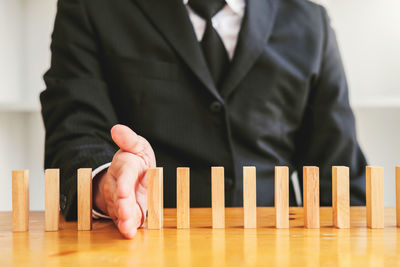 Midsection of man playing piano on table