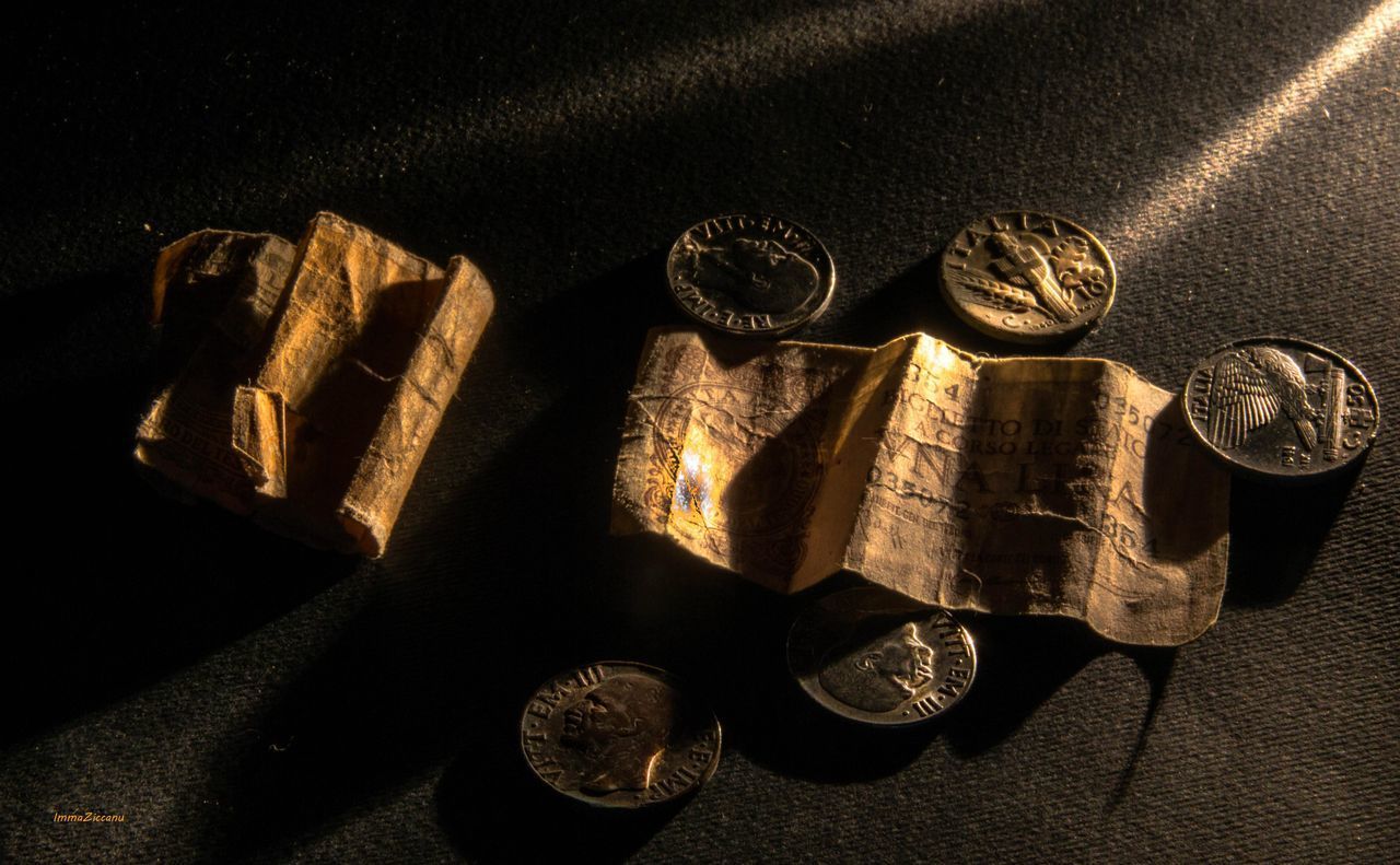 HIGH ANGLE VIEW OF COINS ON METAL