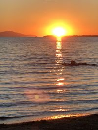 Scenic view of sea against romantic sky at sunset