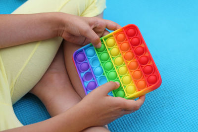 Close-up of boy playing with multi colored lights