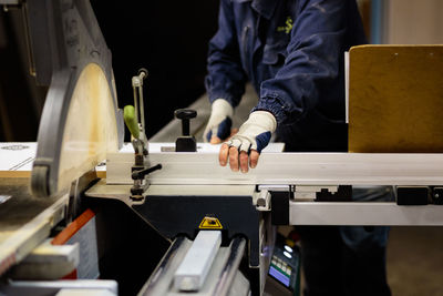 Midsection of man working at workshop