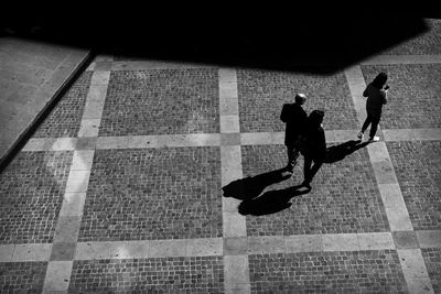 High angle view of people walking on street in city