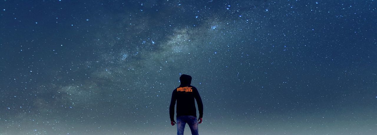 night, standing, lifestyles, leisure activity, rear view, men, star field, low angle view, blue, sky, star - space, silhouette, waist up, astronomy, exploration, three quarter length, copy space, dark