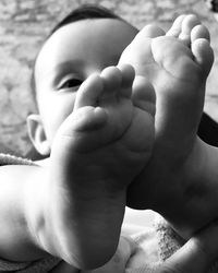 Close-up of baby lying on bed