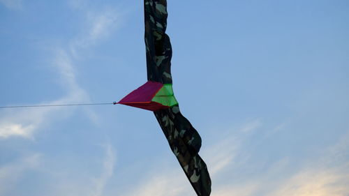 Low angle view of flags hanging against sky