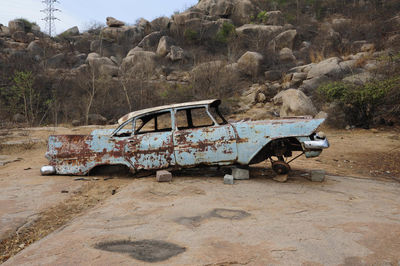 View of abandoned car on land