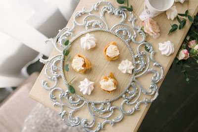 Delicious sweets on a beautiful silver glass tray on the table. candy bar at a wedding or party