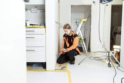 Young woman renovating house