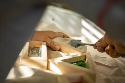 Midsection of man holding paper on table