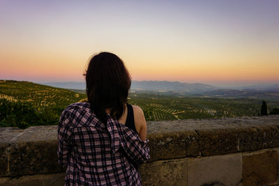 Rear view of woman looking at sunset