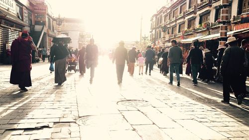 People walking on sidewalk in city