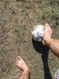 Low section of woman standing on field