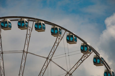 Low angle view of ferris wheel against sky