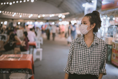 Series photo of young woman tourist wear surgical medical mask touring in street night market